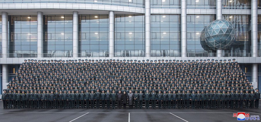 경애하는 김정은동지께서 국가항공우주기술총국을 찾으시여 정찰위성발사성공에 공헌한 과학자,기술자들과 함께 기념사진을 찍으시였다
